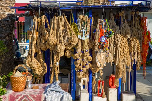 Free A vibrant display of ropes and decorations at an outdoor market stall, perfect for nautical themes. Stock Photo