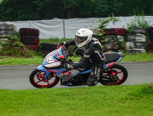 Free Exciting motorcycle race action in Tarlac City's lush outdoor track. Stock Photo