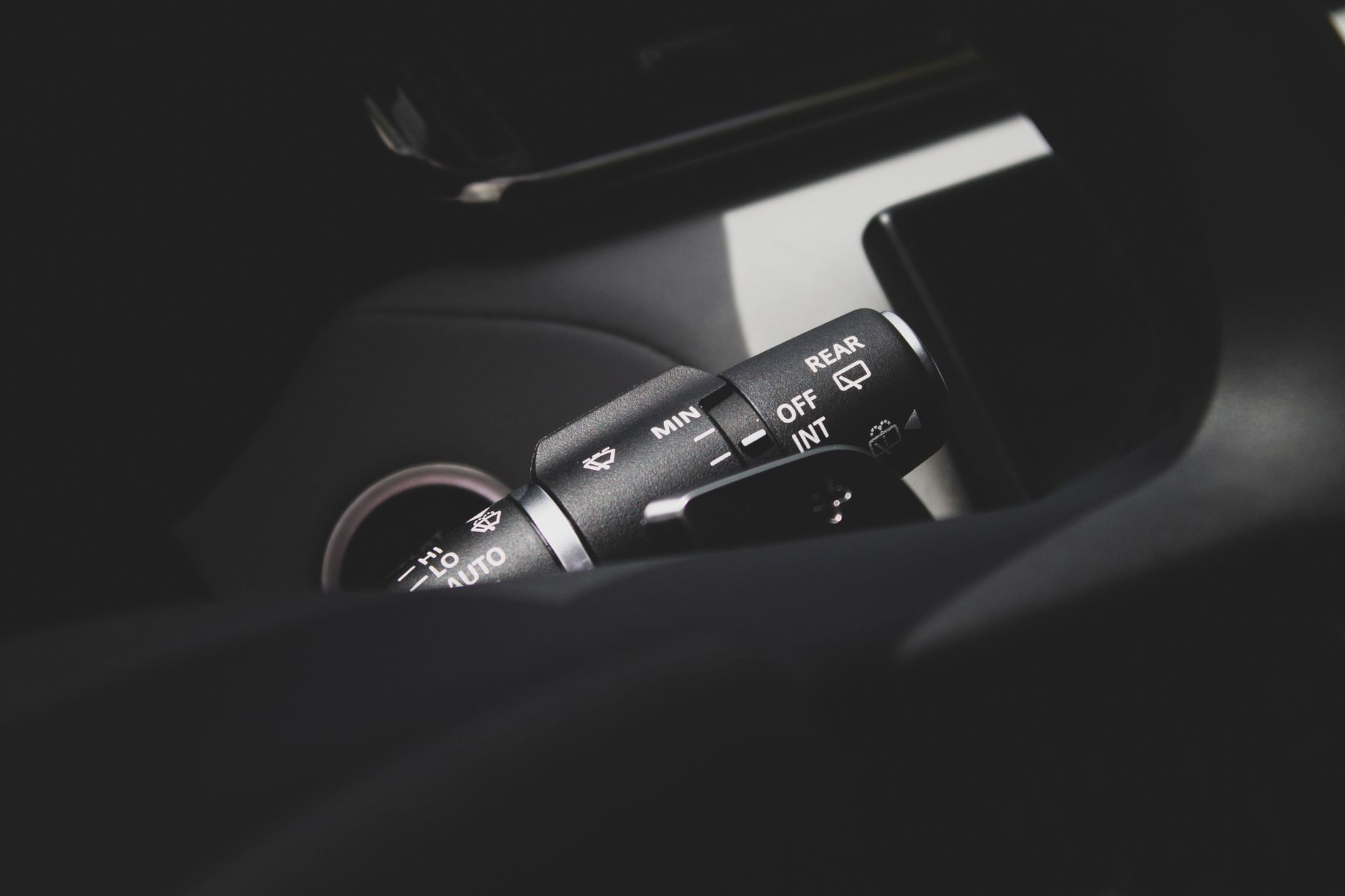 Detailed view of vehicle windshield wiper control, highlighting settings.