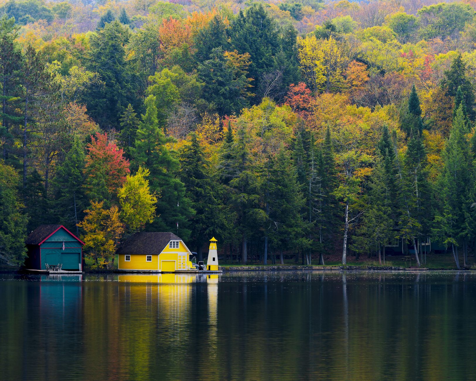 Autumn foliage reflected in Old Forge Pond on the Fulton Chain