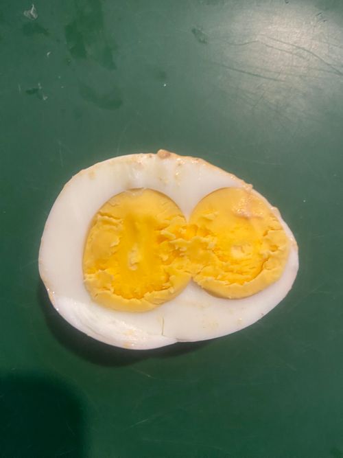 Free Double Yolk Surprise: A Rare Culinary Delight”  Description: Discover the rare and fascinating phenomenon of two yolks in a single boiled egg. This unique occurrence is not only a treat fo... Stock Photo