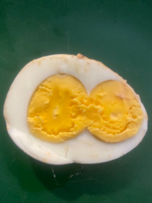 Free Double Yolk Surprise: A Rare Culinary Delight”  Description: Discover the rare and fascinating phenomenon of two yolks in a single boiled egg. This unique occurrence is not only a treat fo... Stock Photo