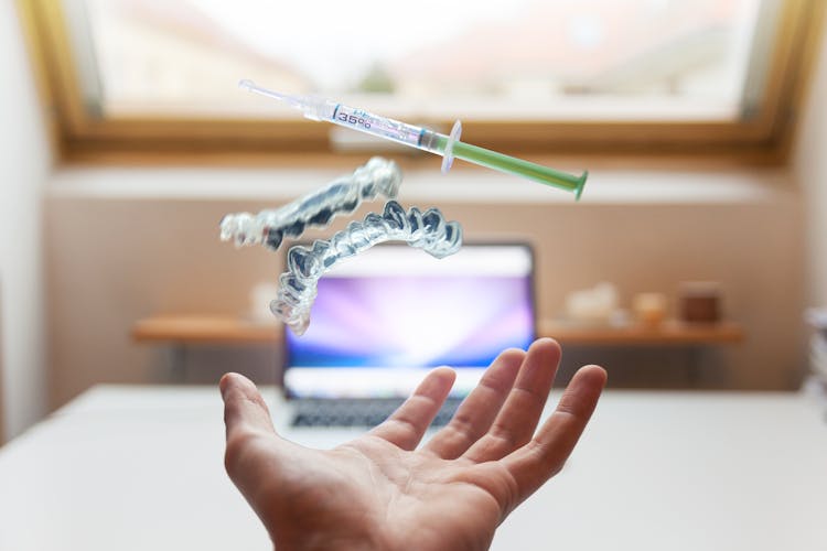 Syringe Floating Near Person's Hand