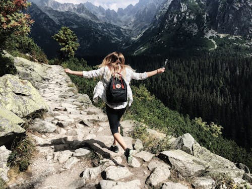 Free Woman Standing on Cliff Stock Photo