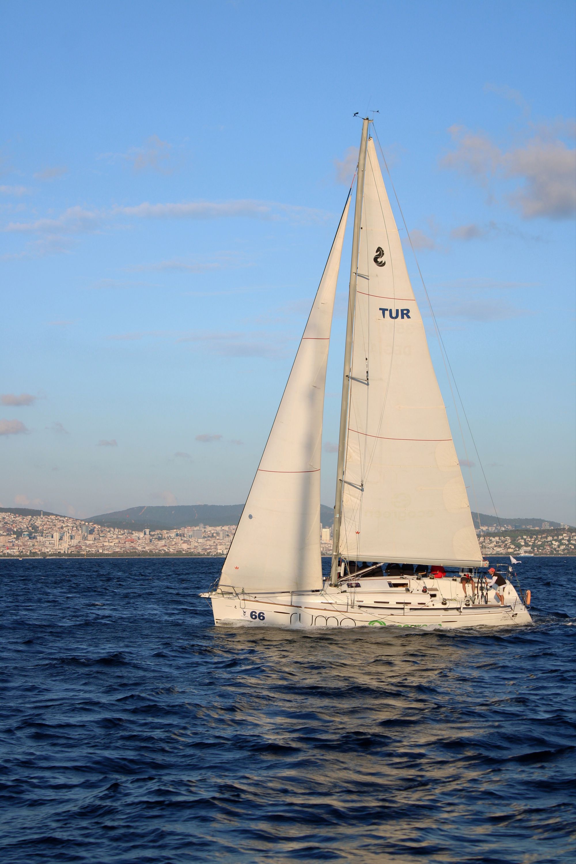 Yacht moored in a sunlit Mediterranean harbour