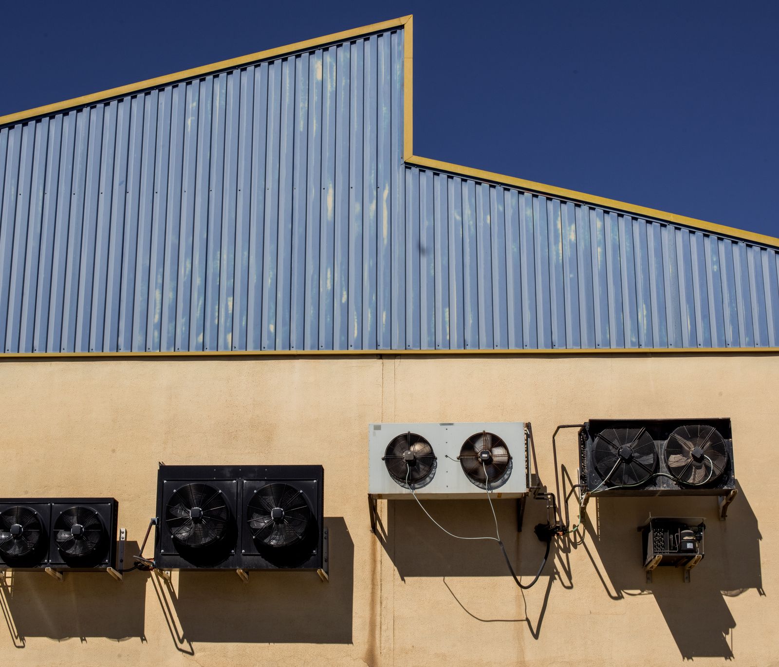 Industrial air conditioning units on a commercial building wall