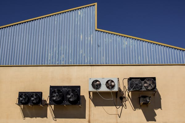 Industrial air conditioning units on warehouse wall
