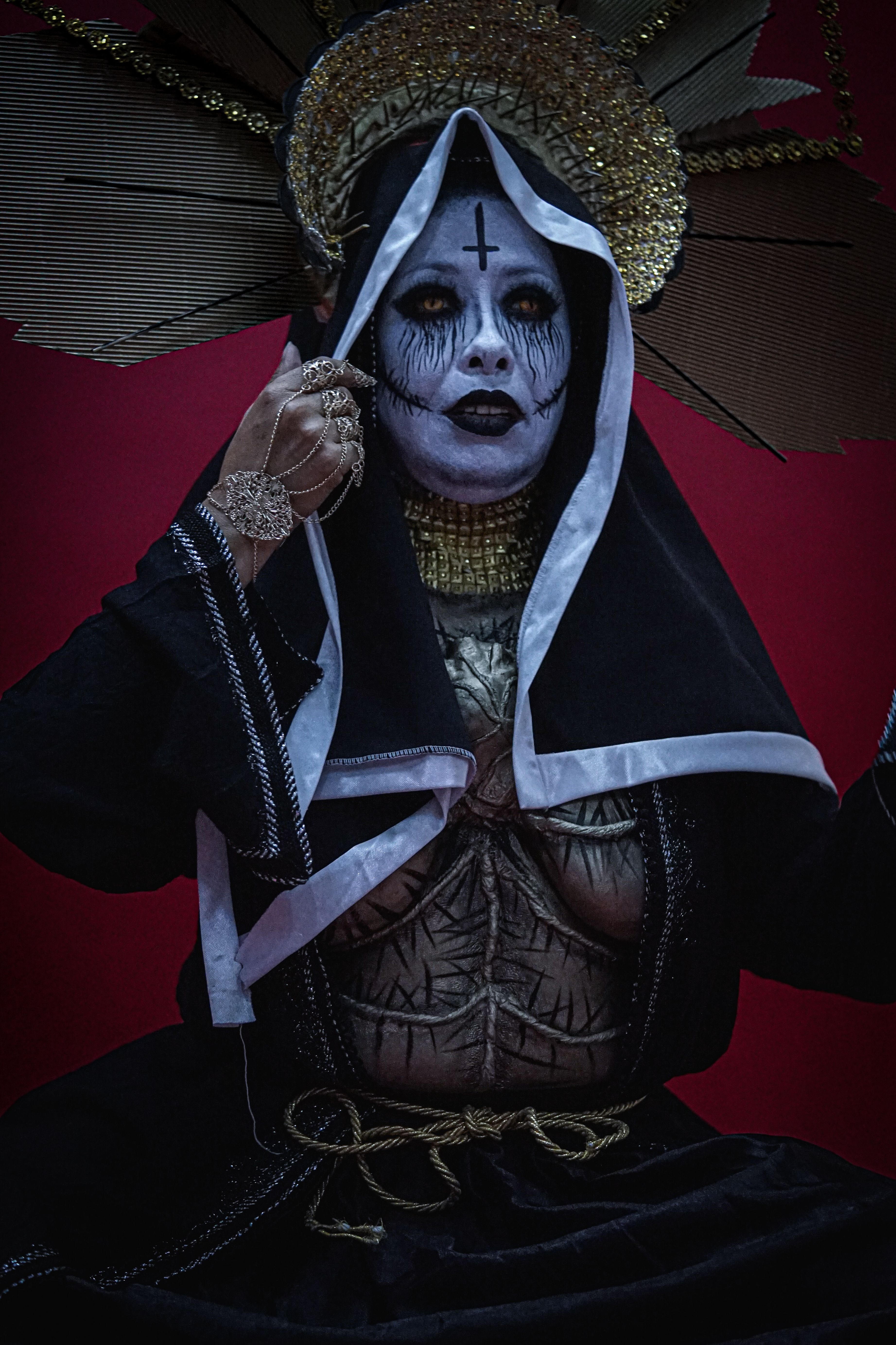 An intense gothic portrait with intricate makeup and costume.