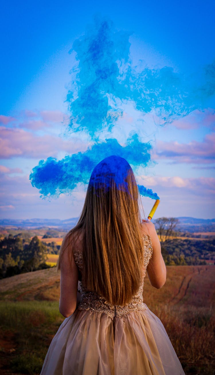 Woman Holding Blue Colored Smoke