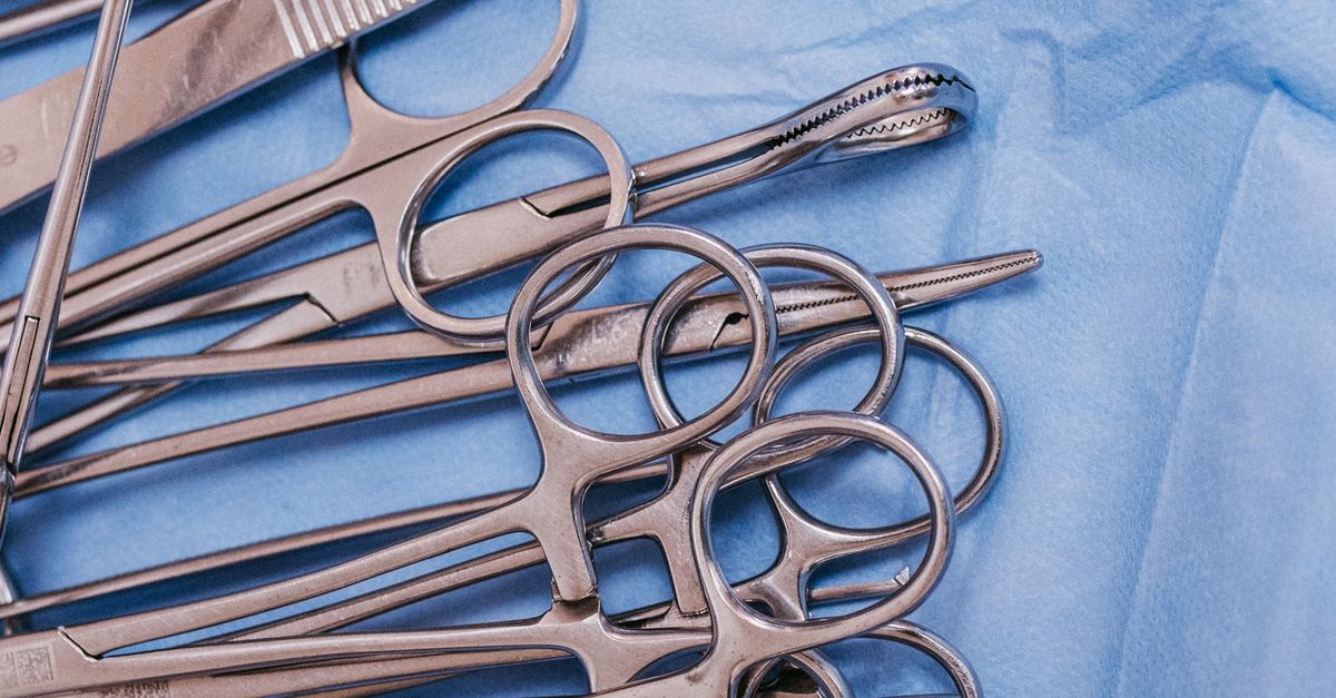 Sterile Surgical Instruments on Blue Drapes · Free Stock Photo