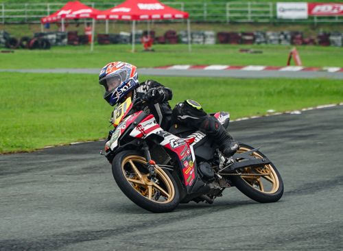 Free Motorcycle racer takes a sharp turn at Tarlac City Circuit. Exciting and dynamic racing action. Stock Photo