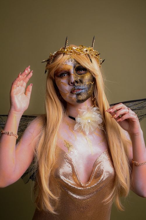 Free Creative portrait of a person in a fantasy costume with gold makeup and accessories. Stock Photo