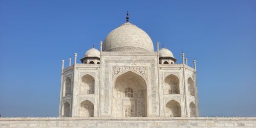 Free The iconic Taj Mahal stands majestically against a clear blue sky, showcasing its stunning architecture. Stock Photo