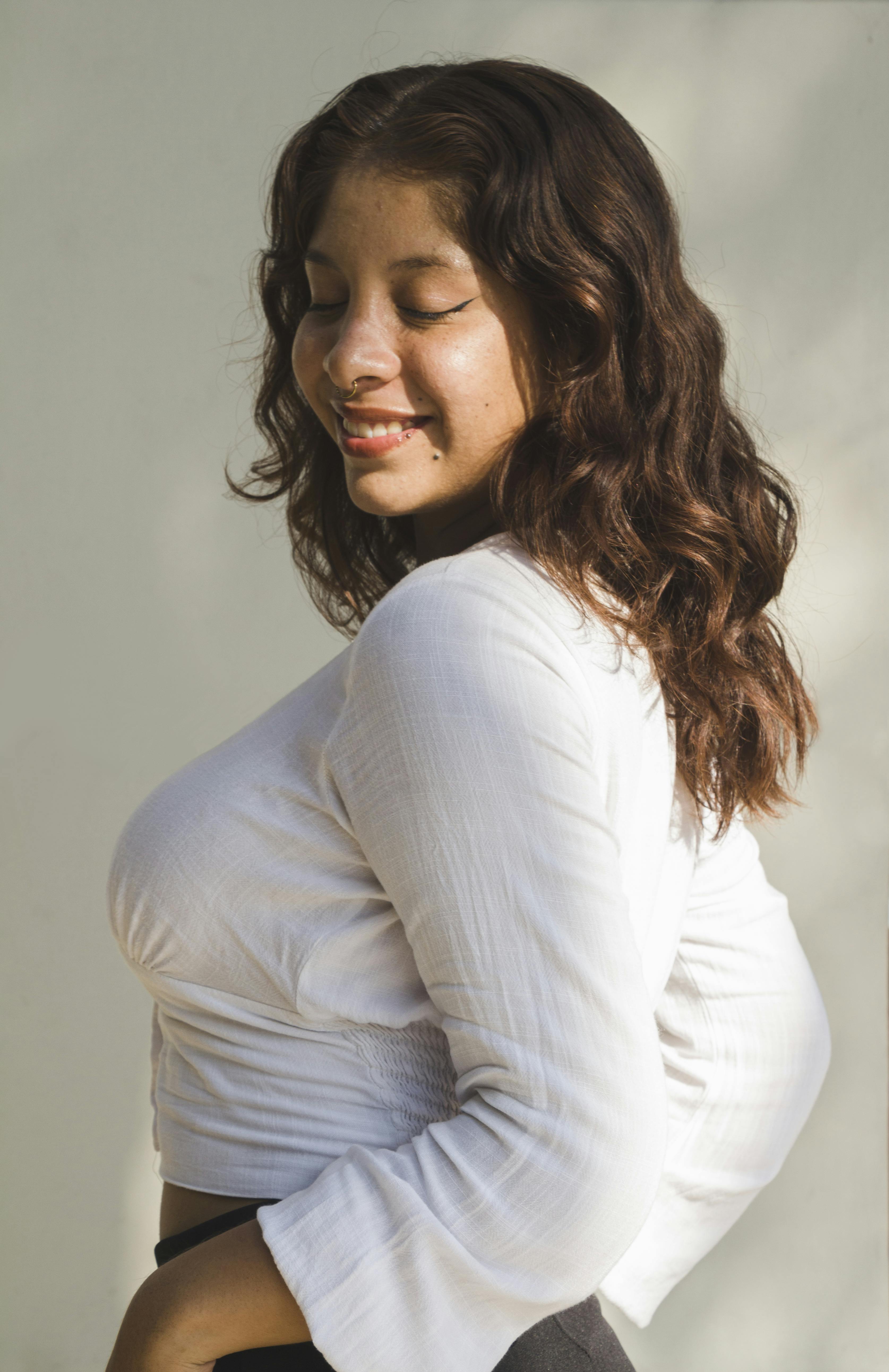 young woman in sunlight with a serene smile