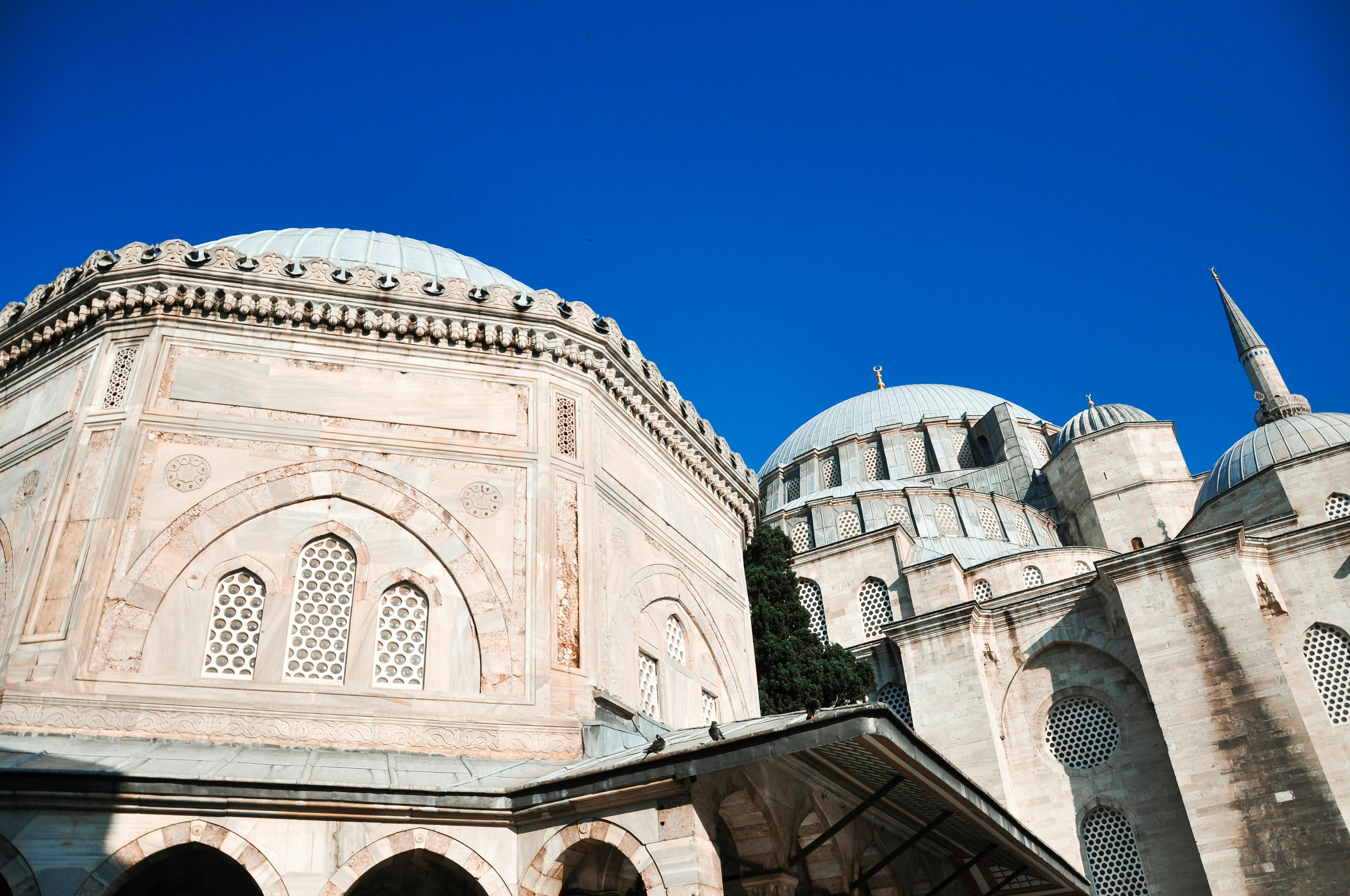 A stunning photo of the Sultan Ahmet Mosque's architectural details under clear blue skies in Istanbul.