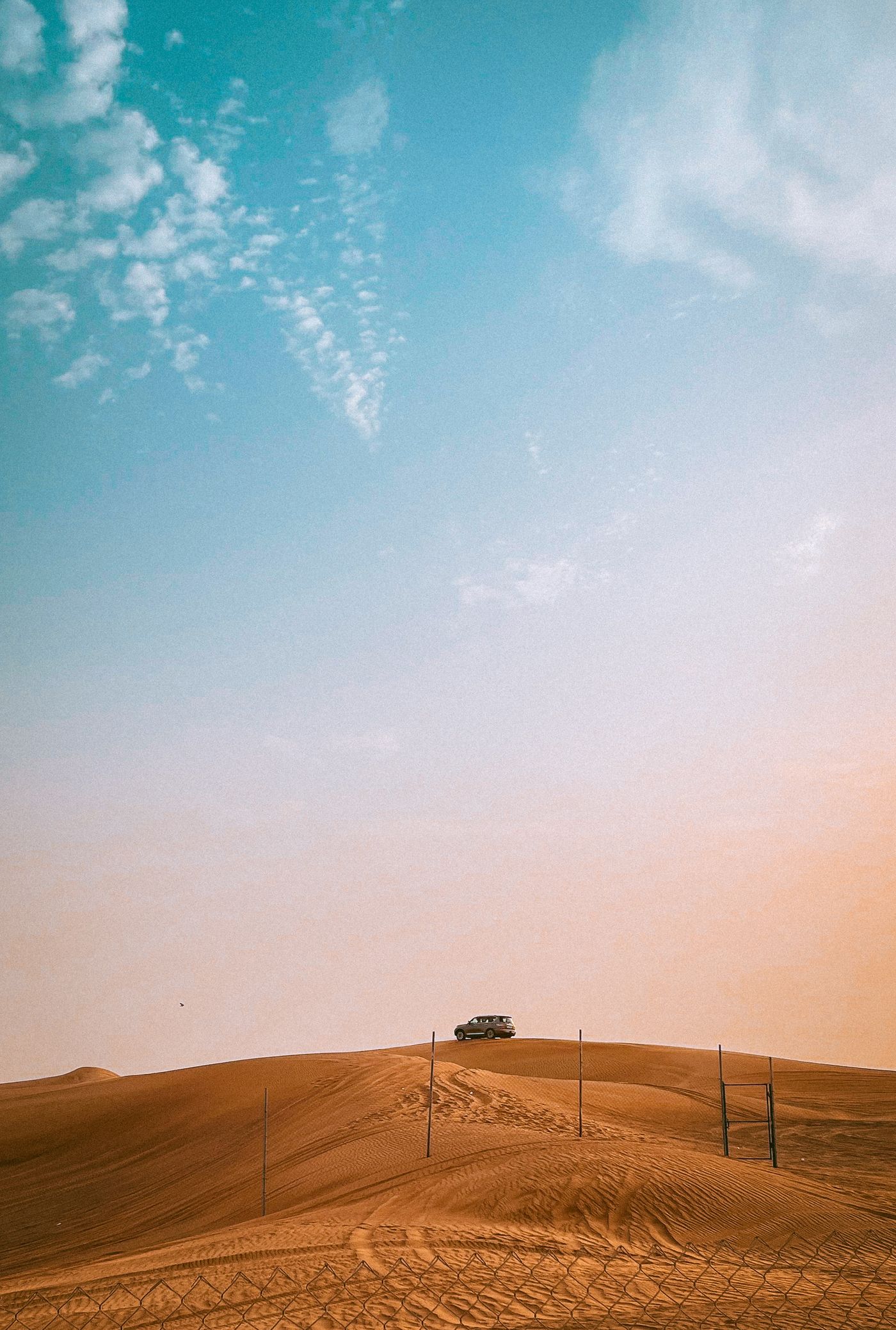 Desert safari vehicle on the dunes of Dubai at sunset