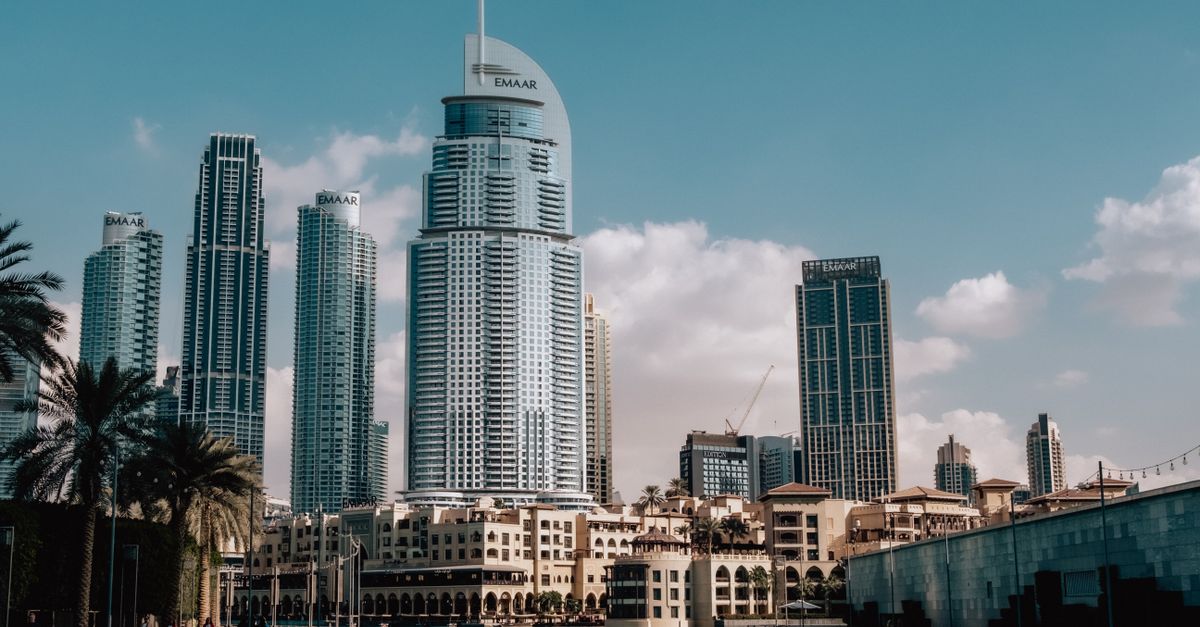 Stunning view of the Dubai skyline, showcasing iconic EMAAR buildings under a clear blue sky.