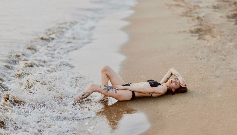Woman in a Bikini Lying on a Beach · Free Stock Photo