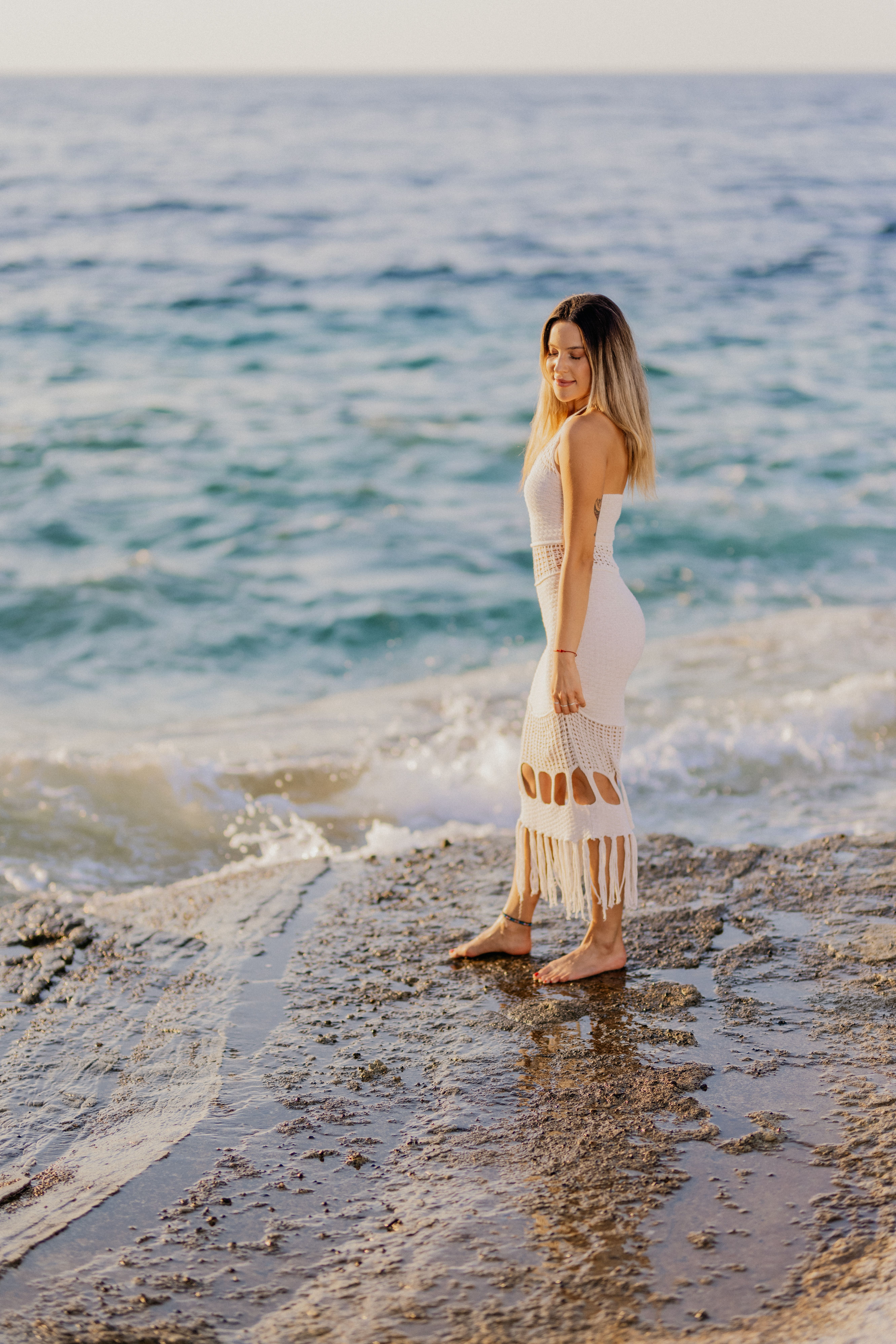 Woman in White Dress by the Sea at Sunset  Free Stock Photo