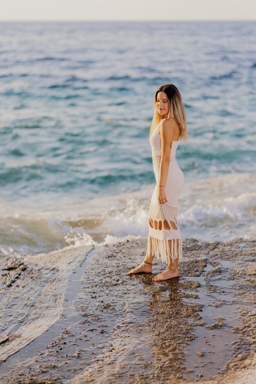 Woman in White Dress by the Sea at Sunset Free Stock Photo Woman in White Dress by the Sea at Sunset Free Stock Photo