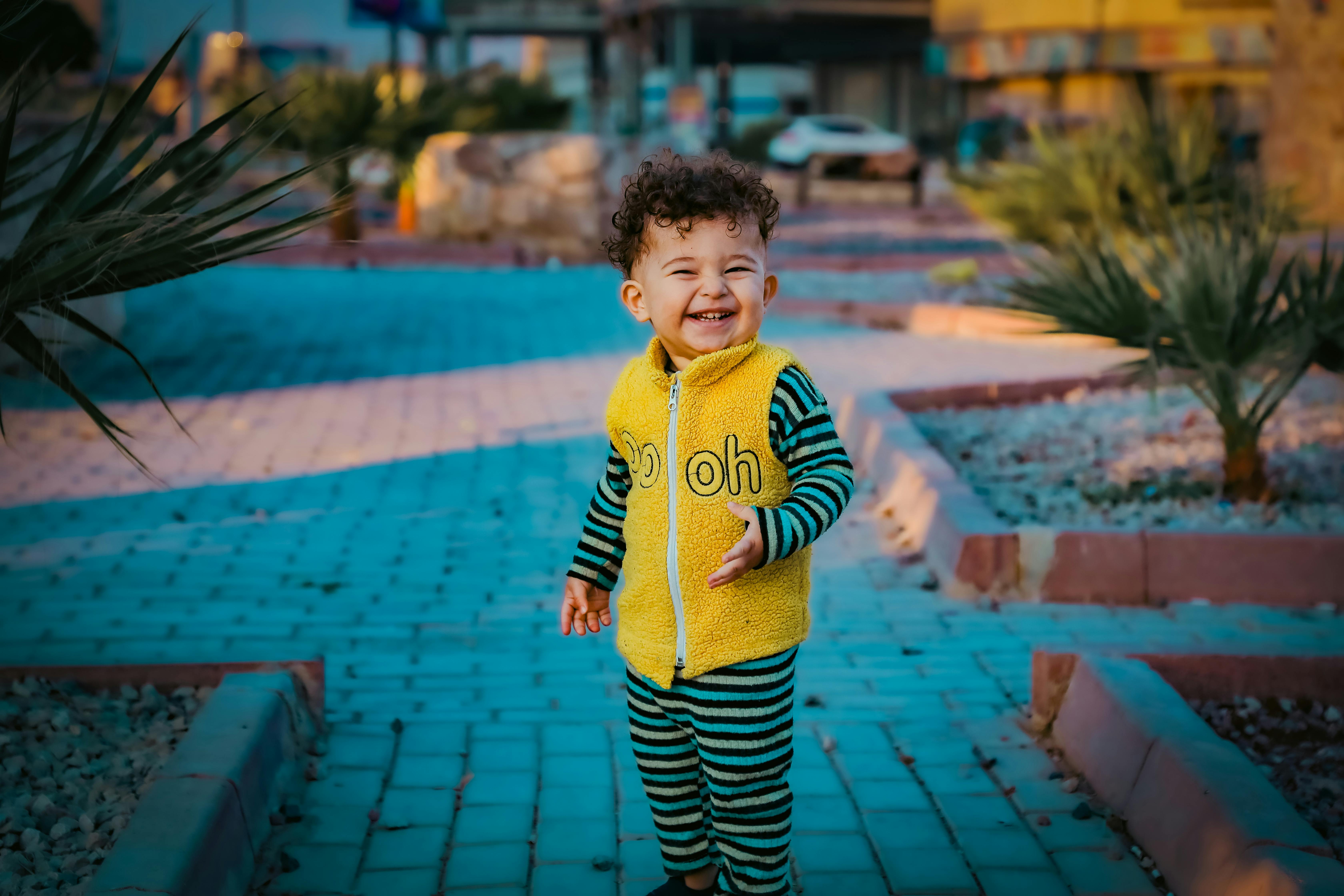 smiling child in colorful outfit outdoors