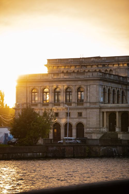 Historic Building by the Riverside at Sunset · Free Stock Photo