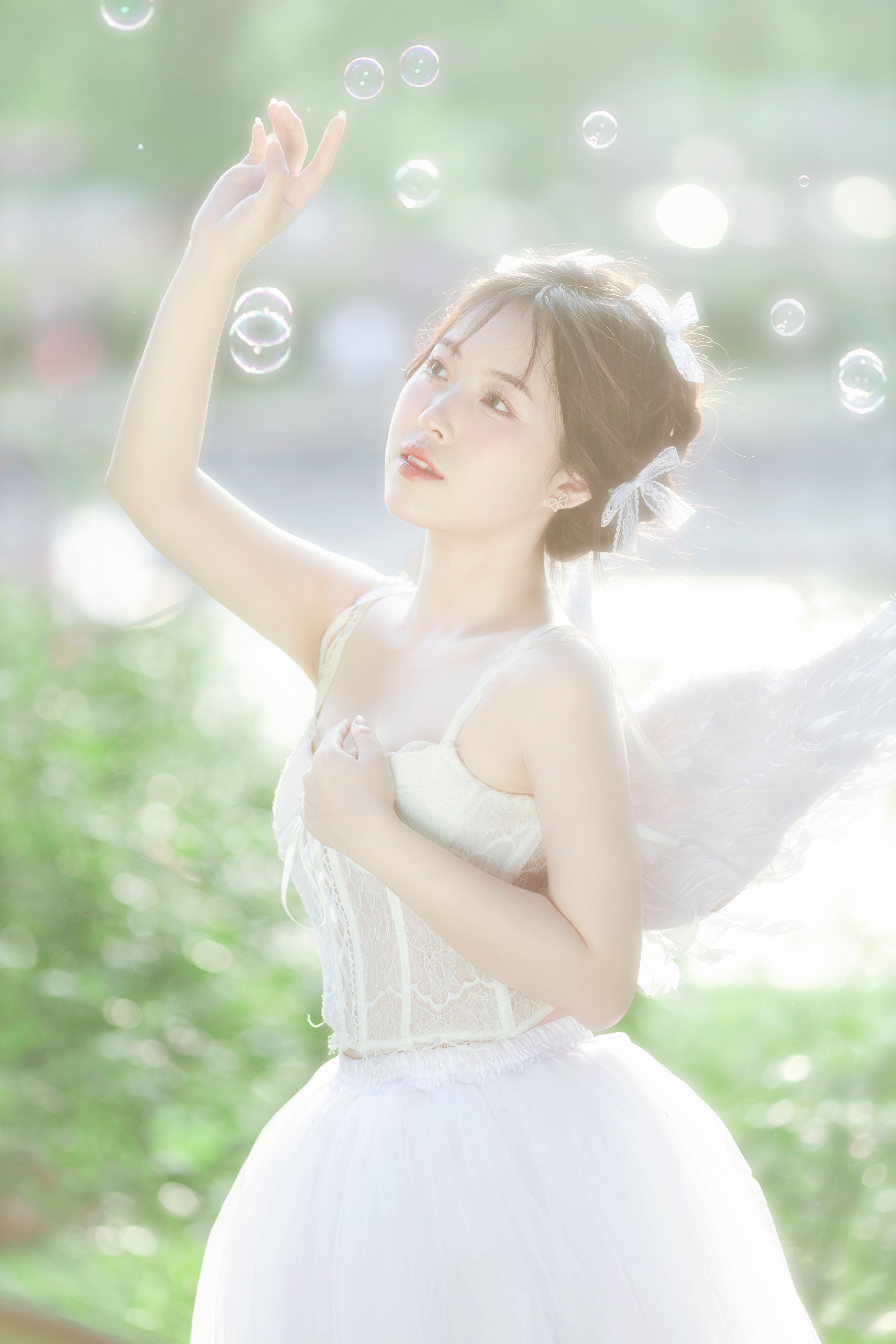 Ethereal image of a woman with angel wings in a sunlit outdoor setting, Hà Nội.