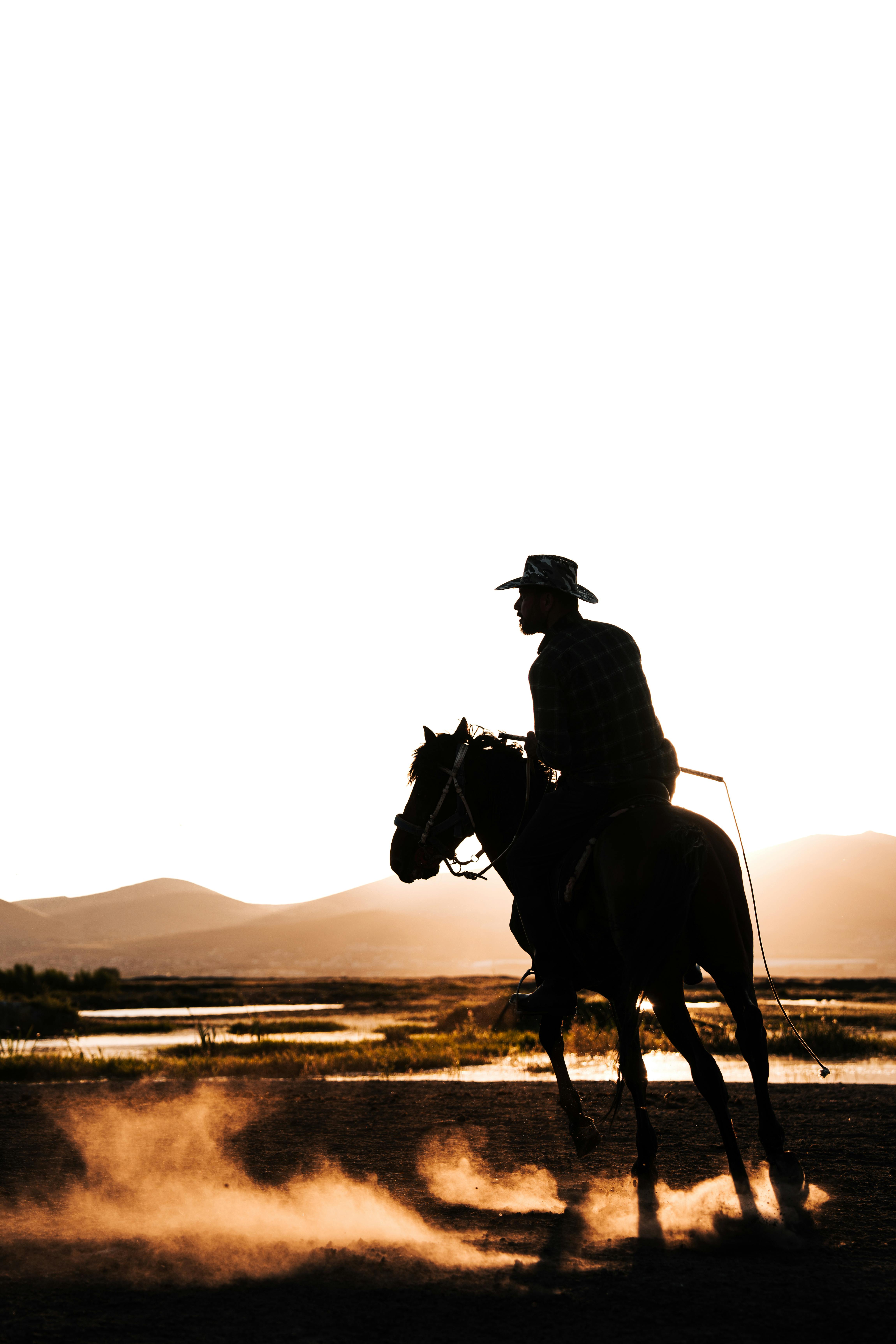 cowboy riding horse at sunset in kayseri