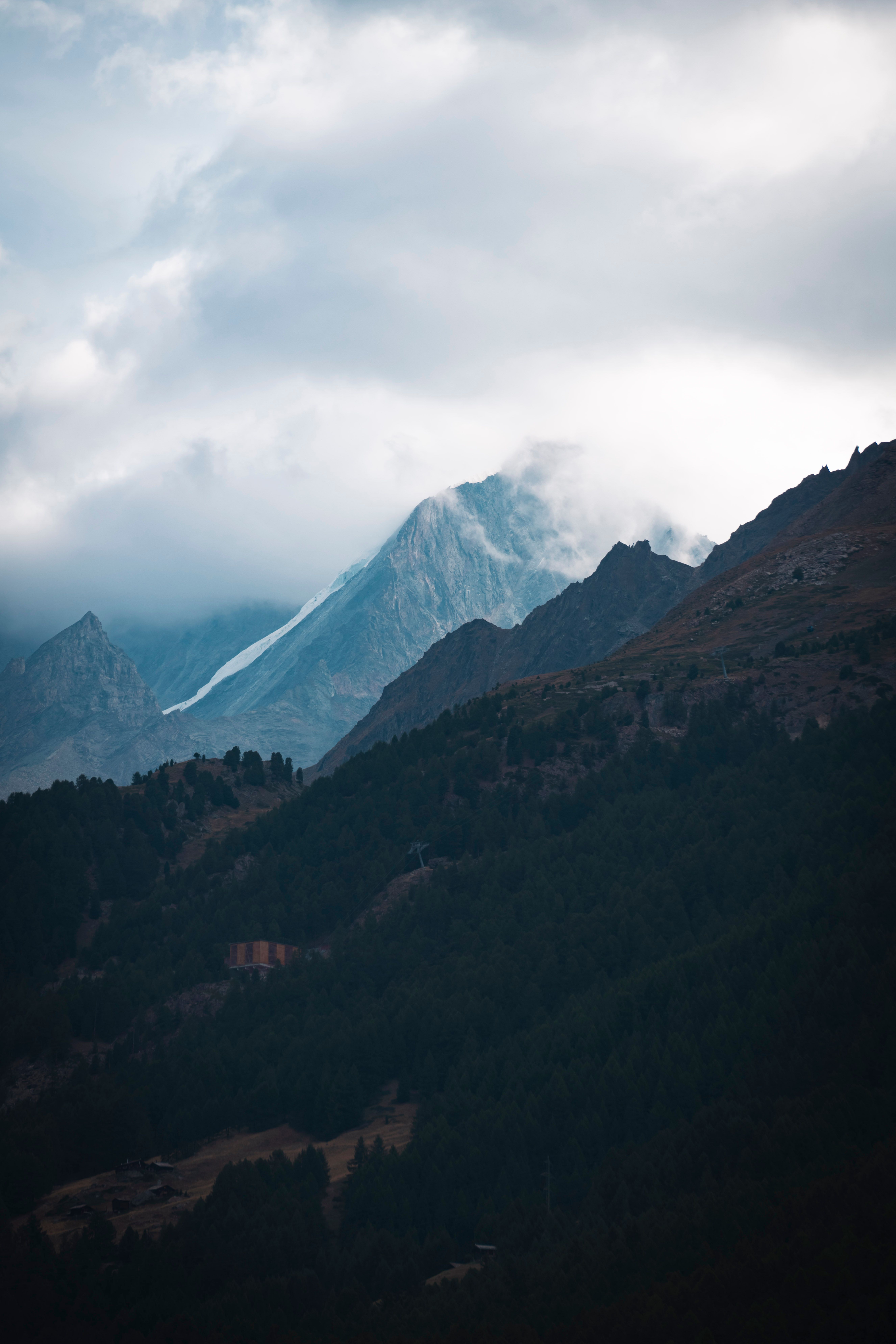 Majestic Mountain Peaks in Cloudy Sky · Free Stock Photo