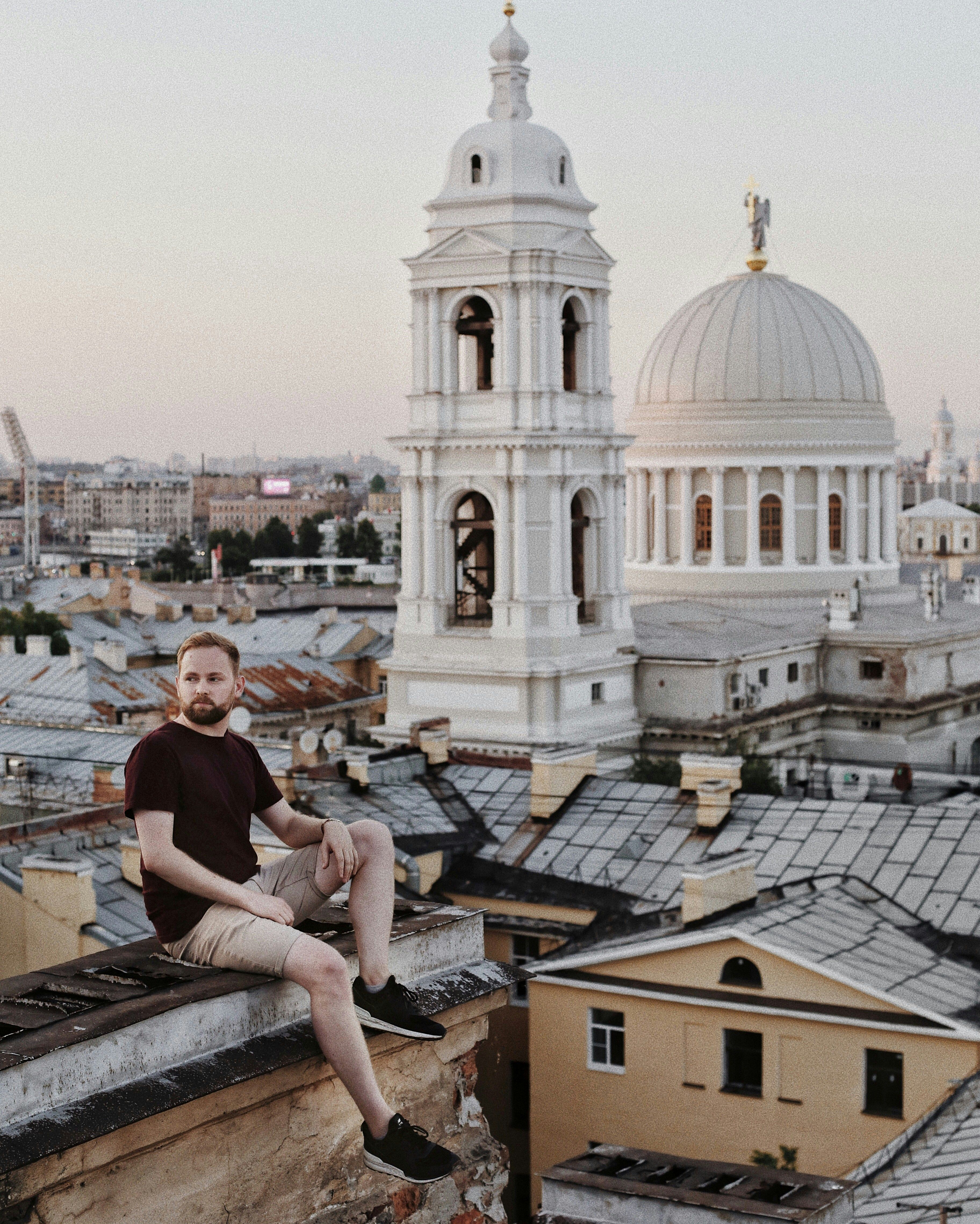 Young Man on Rooftop Overlooking Saint Petersburg · Free Stock Photo
