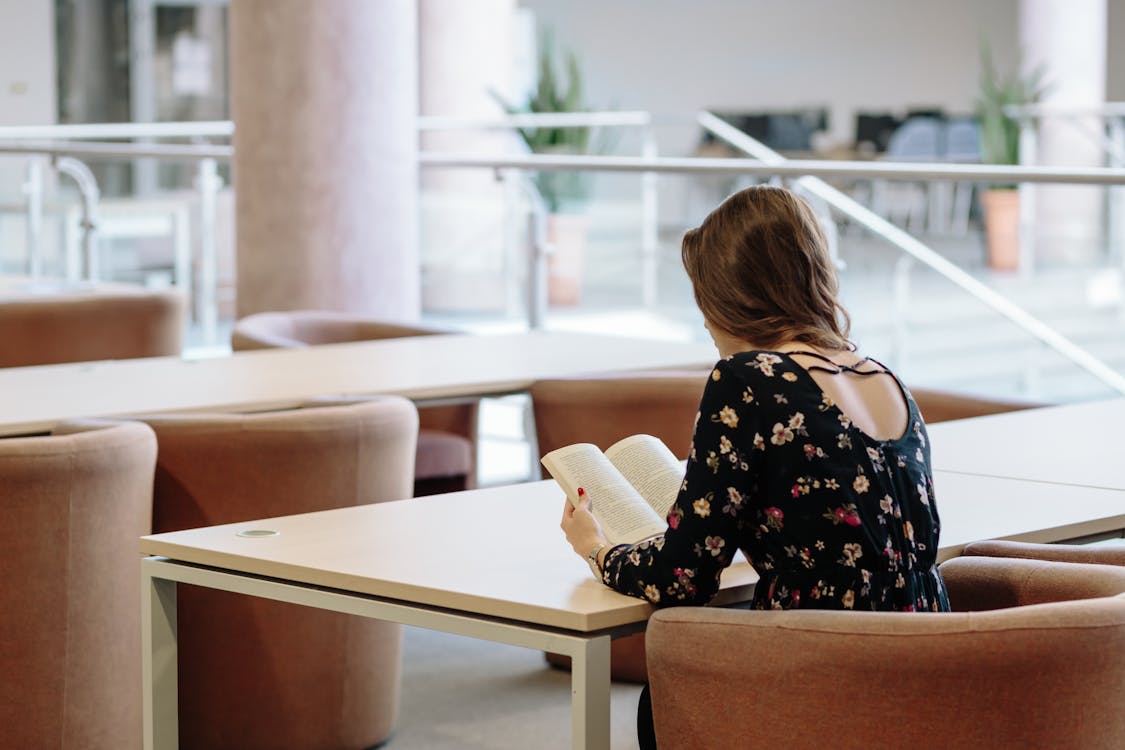 Woman Reading a Book at the Library