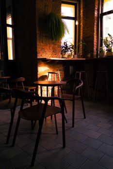 Warm and cozy coffee shop with rustic brick walls and wooden furniture, creating a serene ambiance.