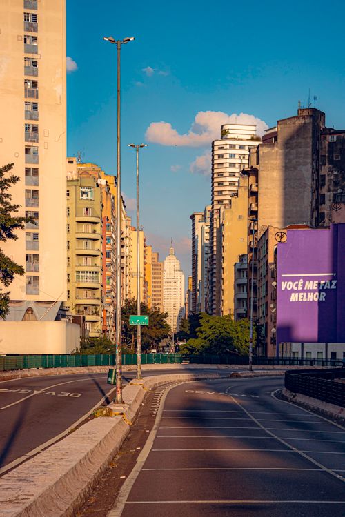 Free Empty street in Sao Paulo with city skyline at sunset, vibrant urban scene. Stock Photo