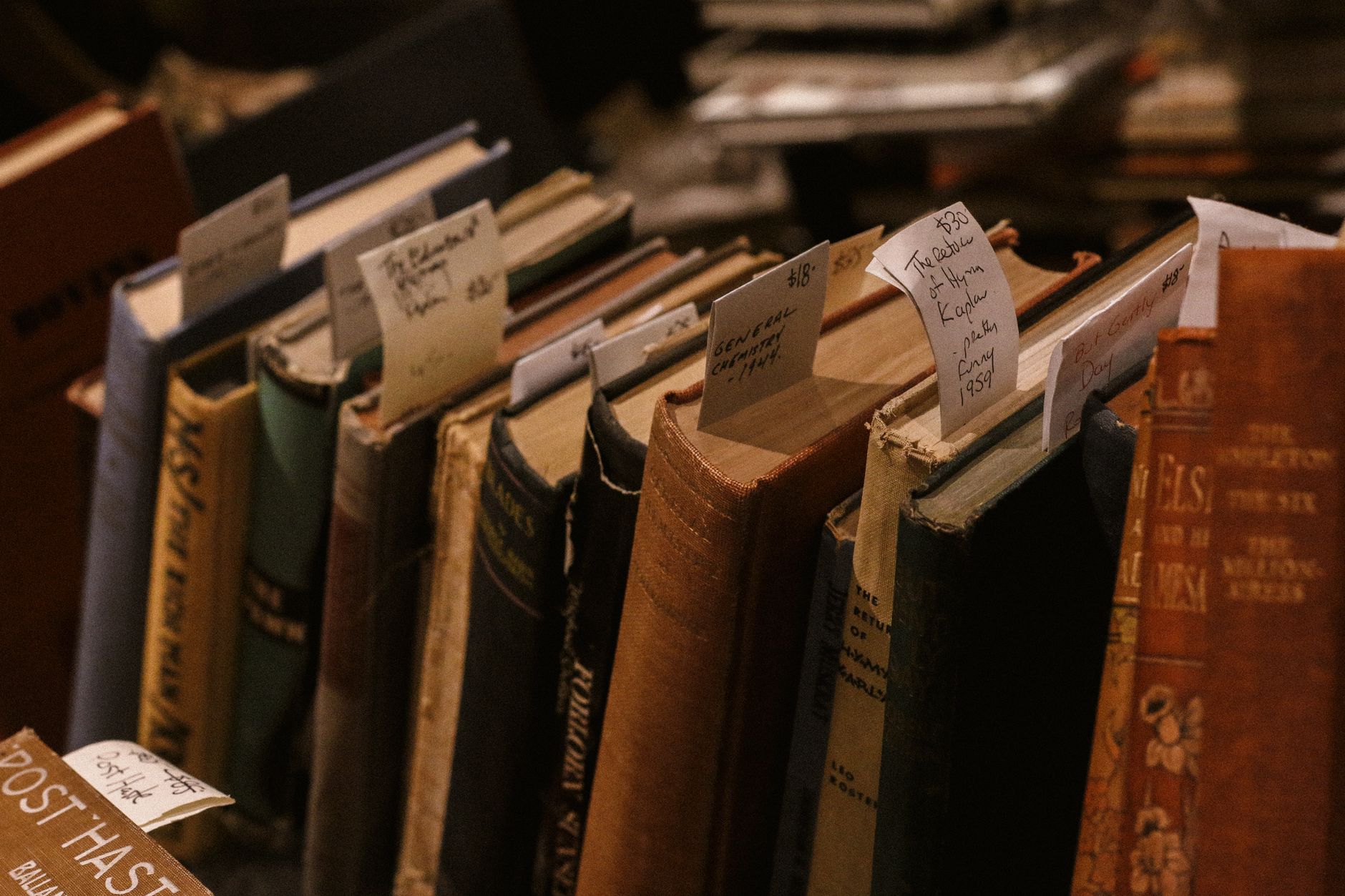 Clifford Geertz books and handwritten field notes displayed beside a map of Bali on a wooden desk