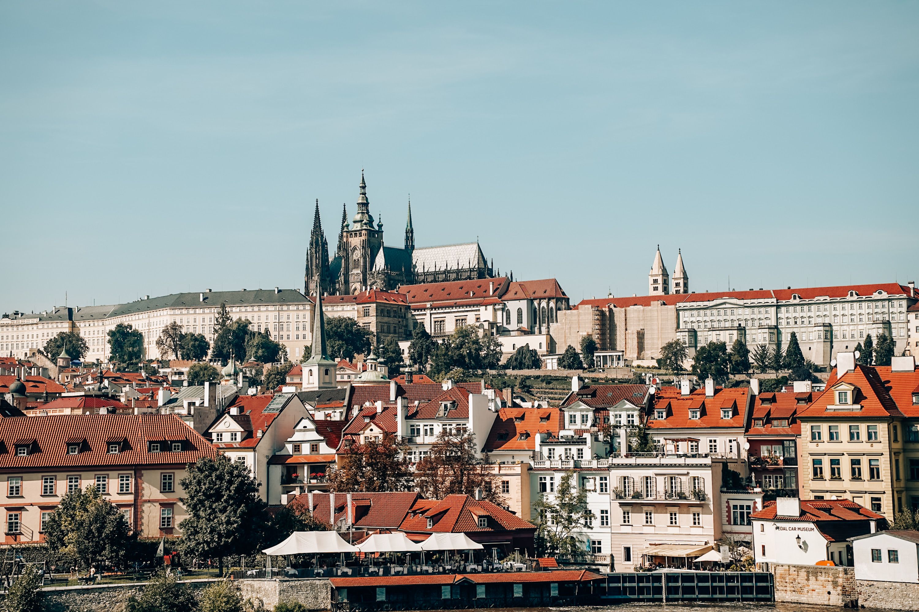 Aerial view of Prague Castle and red-roofed historic buildings