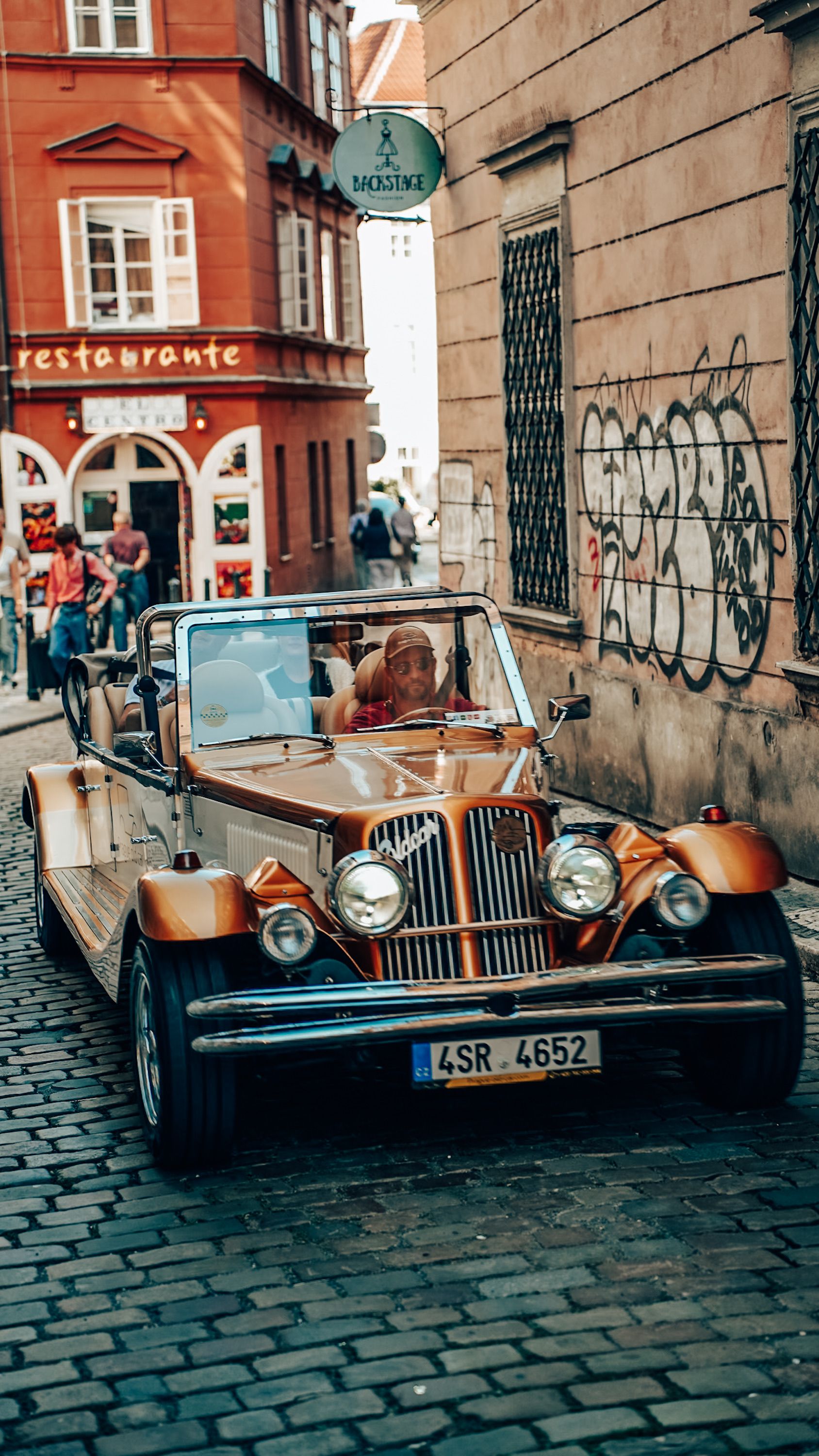 Vintage Car on Cobblestone Street in Charming Old Town · Free Stock Photo