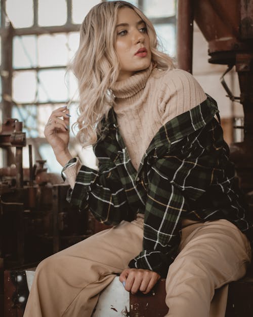 Photo of Woman Sitting Alone Posing While Looking Away