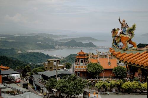 Houses Near Temple Viewing Body of Water