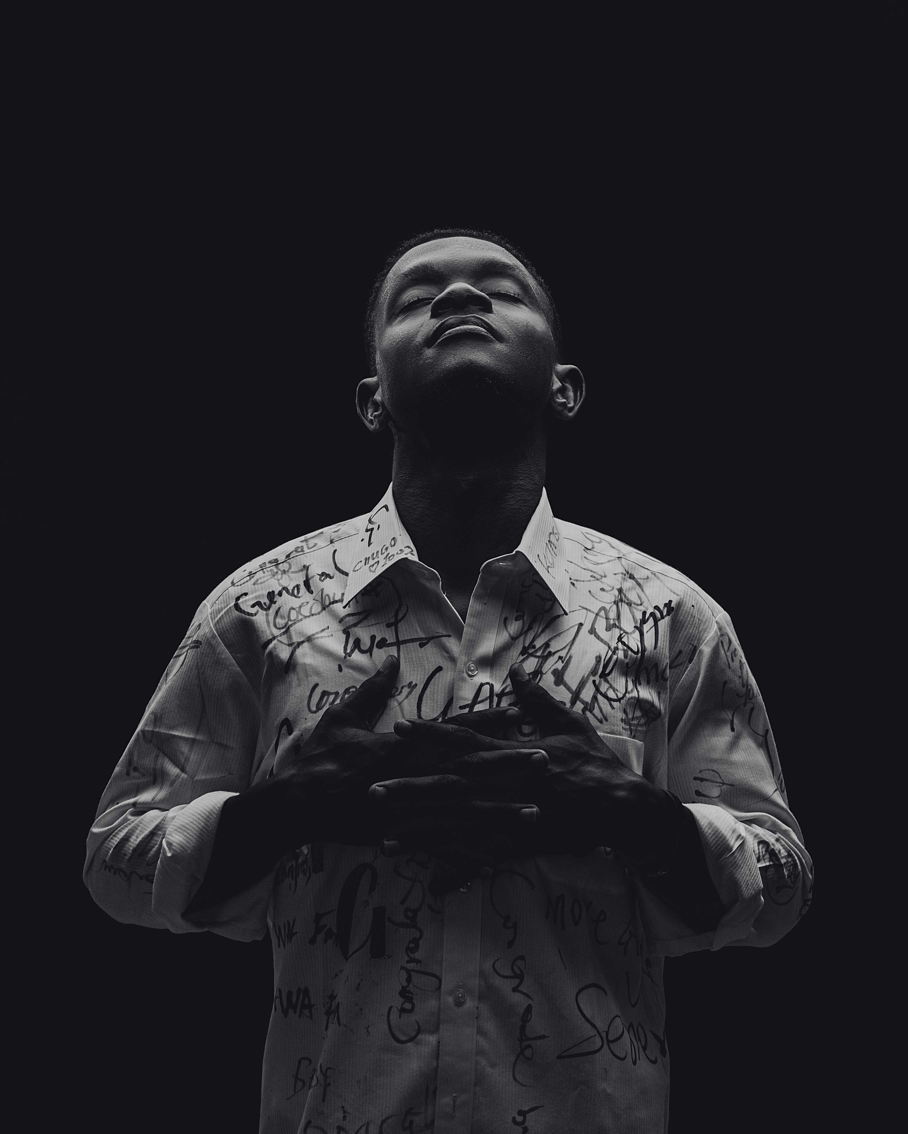 A powerful black and white portrait of a person meditating, symbolizing inner peace and introspection.