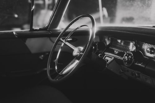 Free Elegant black and white interior of a classic vintage car showcasing timeless design and style. Stock Photo