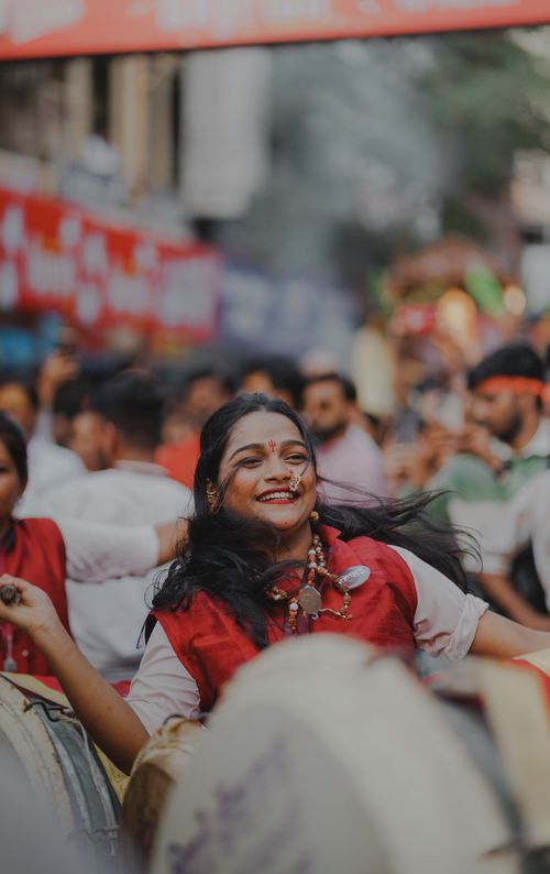 Free Young woman joyfully celebrating Ganesh Chaturthi in vibrant Pune, India. Stock Photo