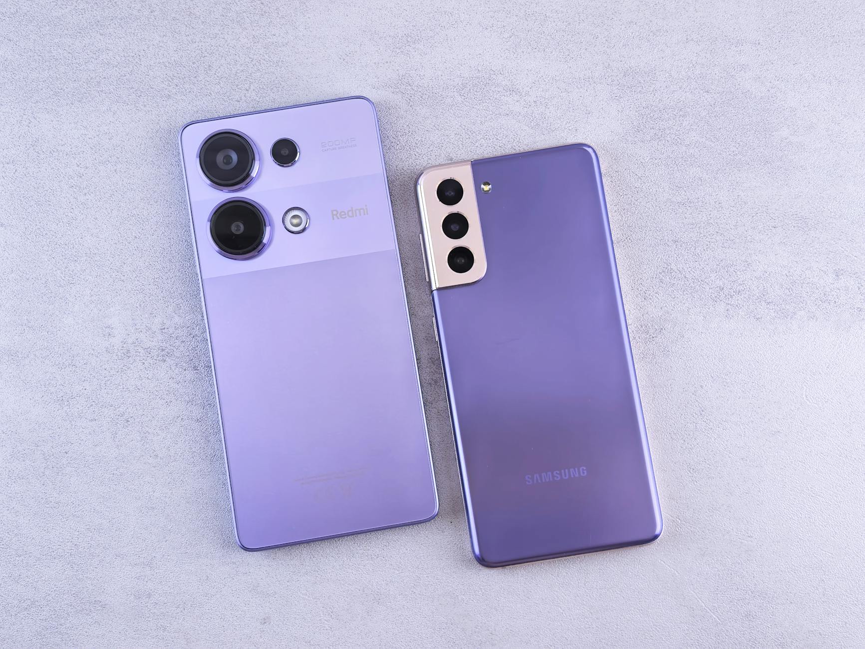 Detailed image showcasing two purple smartphones on a light surface