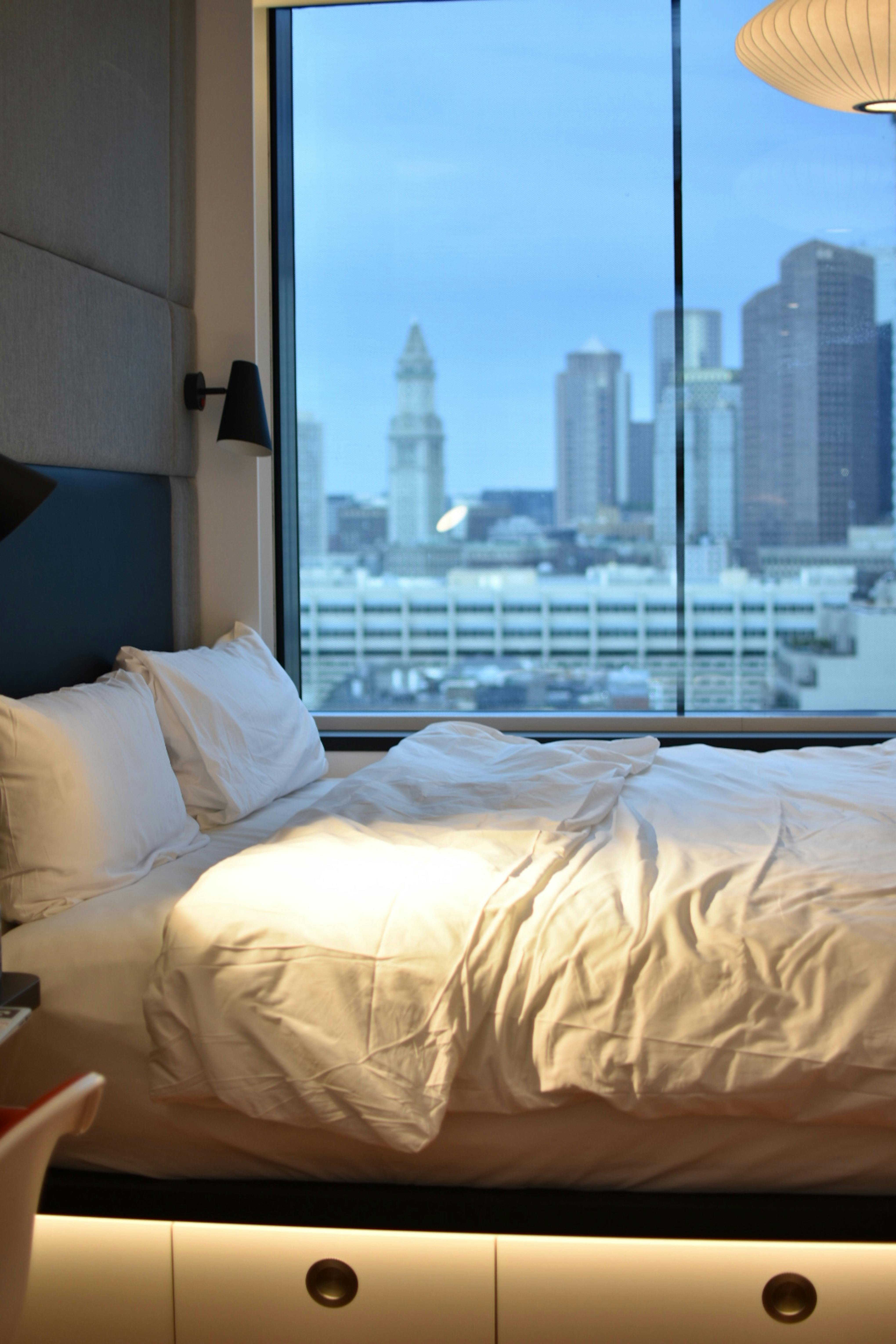 white-pillows-on-bed-beside-window-free-stock-photo