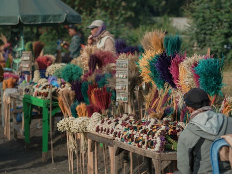 Vibrant dried flowers and handcrafted items at an outdoor market stall.