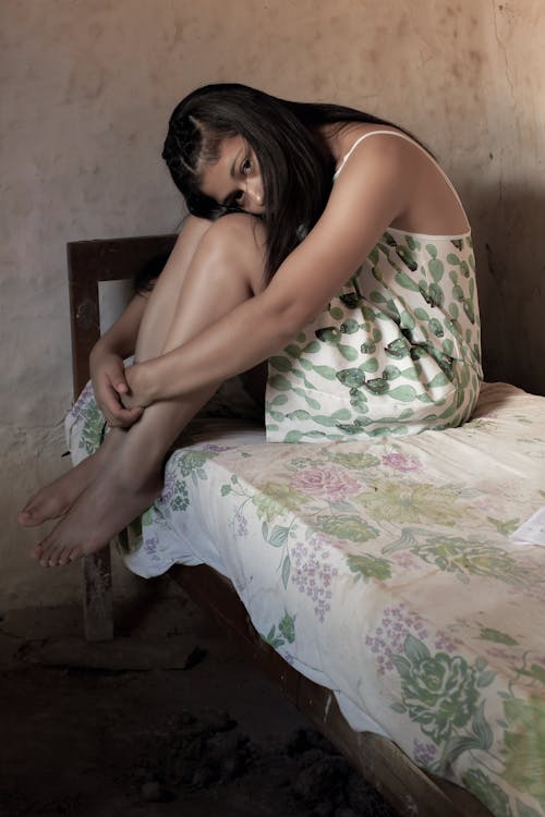 Photo Of Woman Sitting On Bed