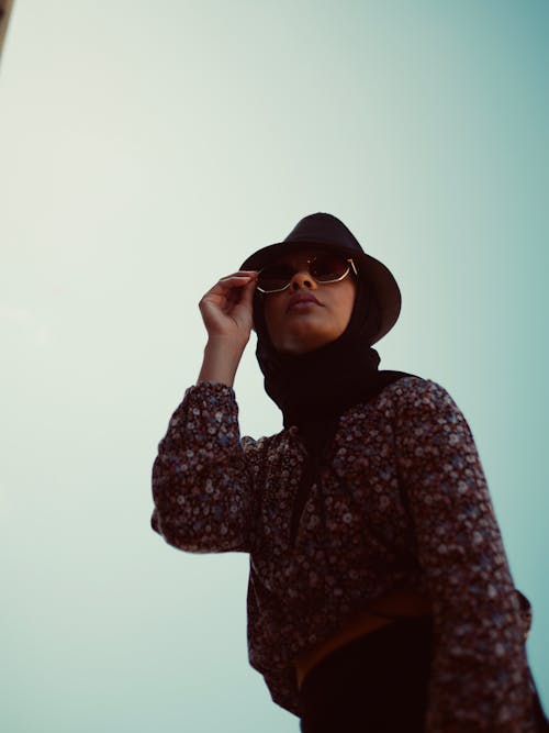 Photo Of Woman Holding Her Sunglasses