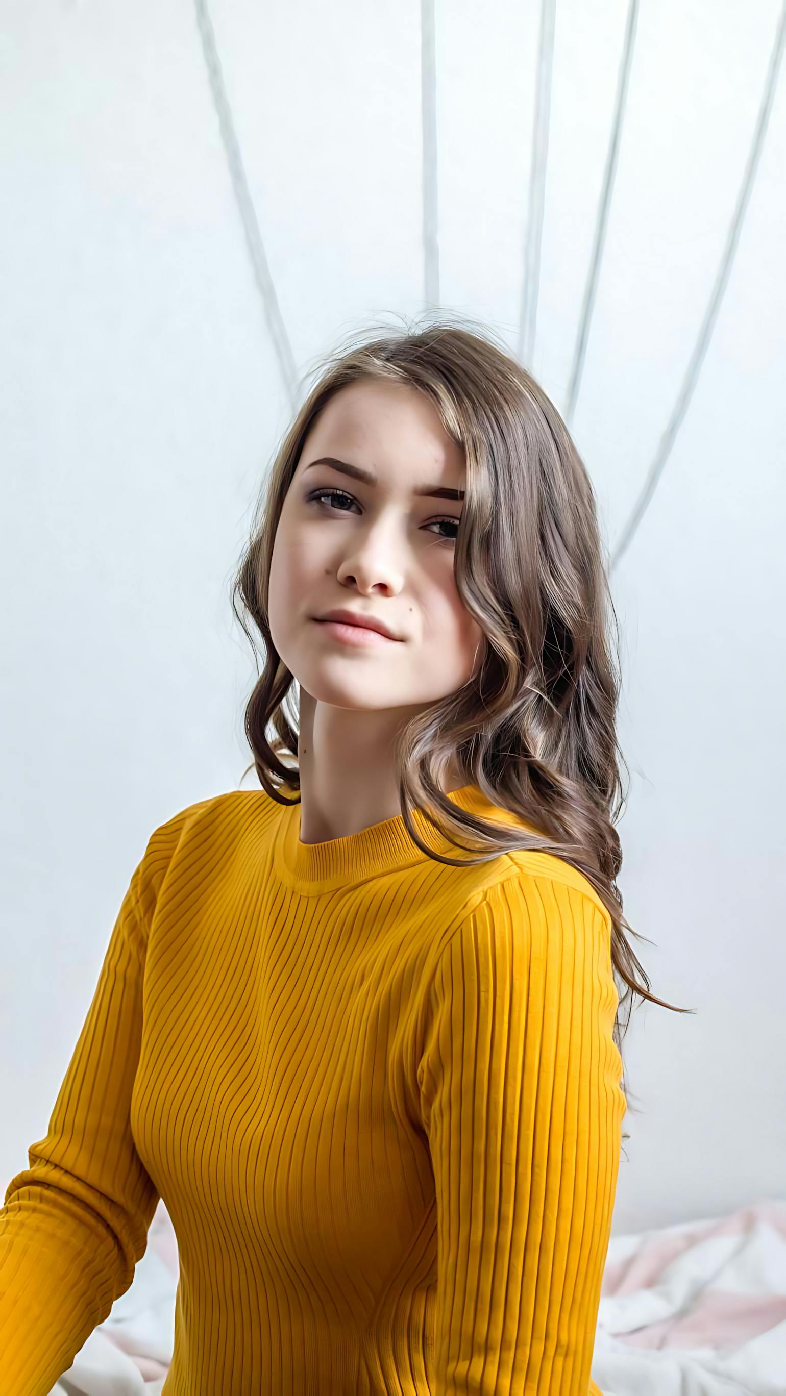 portrait of a stylish young woman in yellow sweater