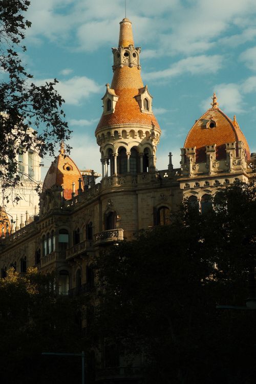 Free Stunning example of Spanish architecture with unique turrets against a blue sky. Stock Photo