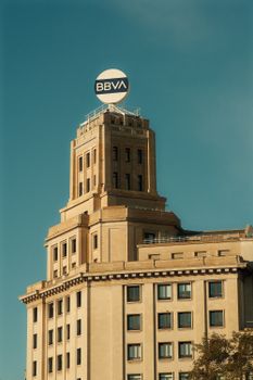 The BBVA building stands prominently with a clear blue sky backdrop.