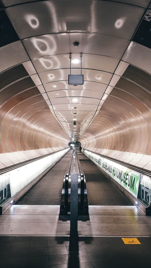 Free Symmetrical view of an escalator in a Rotterdam metro tunnel, highlighting urban architecture. Stock Photo